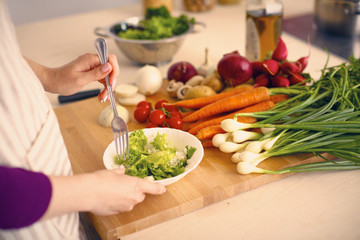 Young Woman Cooking in the kitchen. Healthy Food