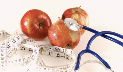 Stethoscope with red apples on a white background