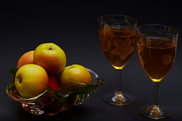 Gifts of nature, on a gradient background glasses of homemade wine and apples.