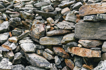 Dump of stones for construction. Stone quarry with boulders. Mountain moraine,  barrier to tourist.