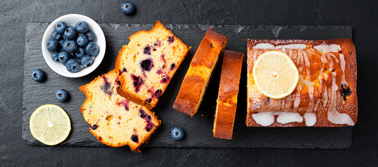 Homemade Blueberry Lemon Cake on black stone background.
