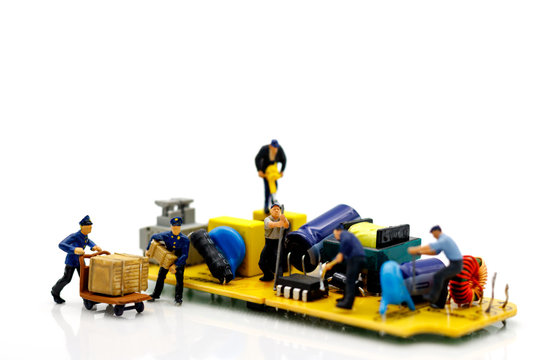 Miniature people: Engineers fixing error on chip of circuit board. Computer repair concept.