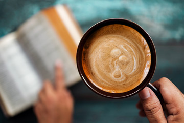 Relaxation Concept. Relaxing by Reading Book and Coffee in Cozy Place or Cafe, Top View, Selective Focus on Foreground