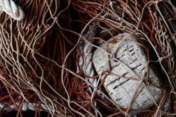 Fishing net and float in a pile in closeup