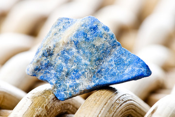 Macro photography of a lapis lazuli stone on a wicker background