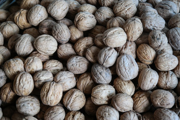 Walnuts with and without shells. Background of fresh walnuts.