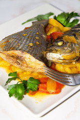 stewed fish dish with potatoes and peppers