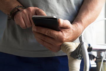 man using mobile phone in the gym