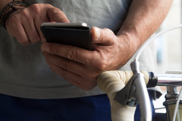 man using mobile phone in the gym