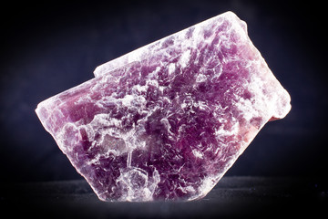 Macro photography of a lepidolite stone on a black background