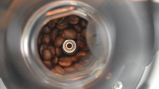 Video showing the coffee beans being poured into the coffee grinder. Full HD