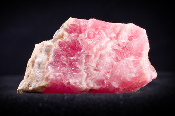Macro photography of a rhodocrosytis stone on a black background