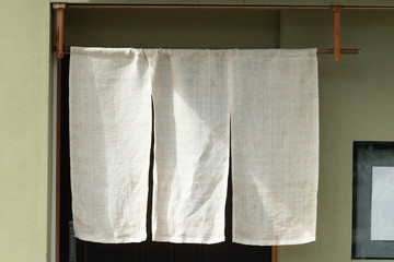 The curtain-like fabric that hangs in front of traditional Japanese restaurants and shops not only serves as a signboard, but holds a larger meaning,