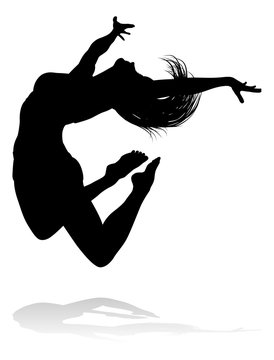 A silhouette woman dancing in mid air jumping