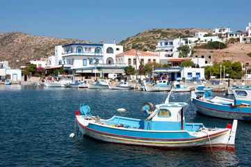 Fototapeta na wymiar Greece – Lipsi island. Small, traditional fishing boats at anchor in the harbor.