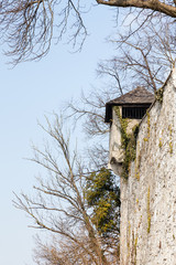 A fortified tower adorns the fortified walls on Kapzinerberg.  Kapuzinerberg is a hill in Salzburg, Austria.