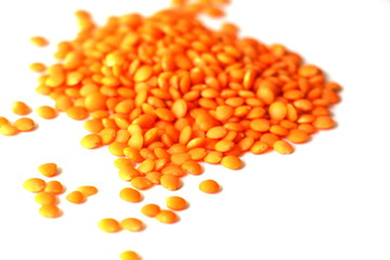 Red lentils on white background. Different forms of dry lentils. Lentils red in a transparent glass jar. Handful of legumes.