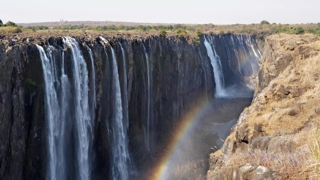 Majestic Victoria Falls Waterfall with Rainbow on Zambezi River in Zimbabwe, Africa