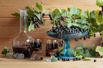Homemade black currant liqueur and fresh berries .