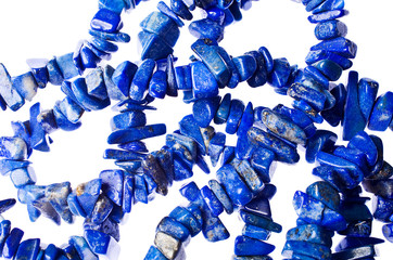 Closeup of a lapis lazuli necklace on a white background