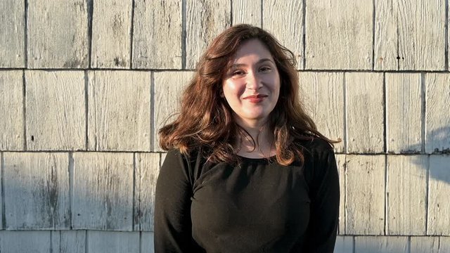 Portrait young woman giggle looking at camera smiling and happy