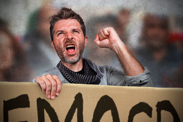 attractive and upset political activist man protesting in street march screaming holding rights billboard shouting against government demanding for justice and democracy respect