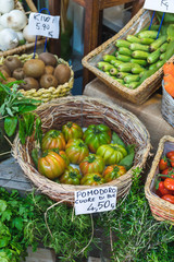 Close-up of baskets with vegetables and fruits in Italy - English translation "Tomato"