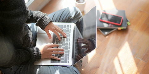 Close-up view of young female freelancer working on her project with laptop computer