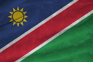 Towel fabric pattern flag of Namibia, a white-edged red diagonal band and triangle is blue with a gold sun and the lower triangle is green.