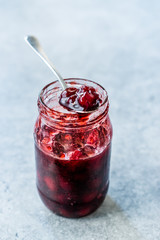 Cranberry Jam in Jar with Spoon / Cranberries Marmalade served with Bread Slices.