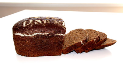 Fototapeta na wymiar Black bread. Bakery products. Dough. Brown flour. Loaf of bread.
