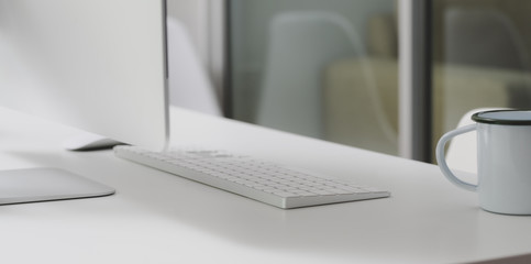Cropped shot of modern workspace with desktop computer and office supplies