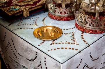 Gold wedding rings on the gold plate in the church