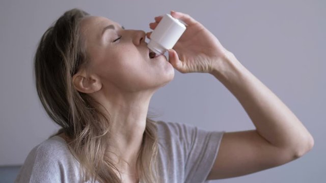 Depressed woman suffering from suicidal depression want to commit suicide by taking strong medicament drugs and pills pain killers while, she sitting at home
