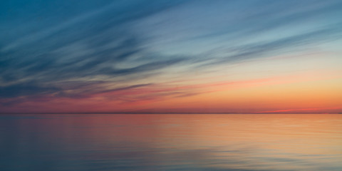 Naklejka na ściany i meble Long-exposure sunrise on the sea