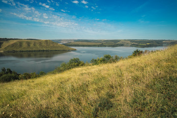 summer morning day scenic view nature reserve park hill land and lake  country side peaceful landscape outdoor environment 