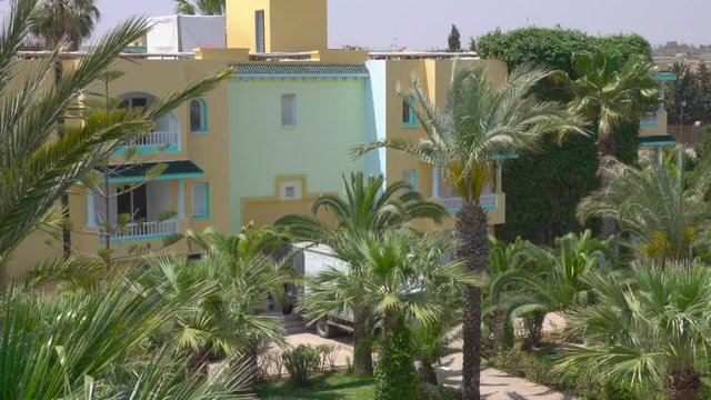 Tropical vacation. Beautiful tropical landscape with palm trees on blue sky background in resort