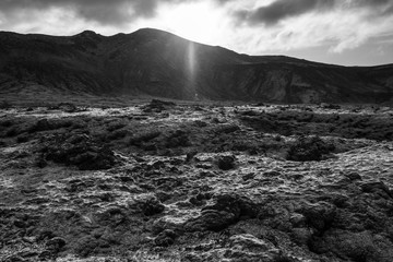 View over the moss and first snow covered lava field in the nature reserve Reykjanesfólkvangur near Hafnarfjörður / Hafnarfjördur on the mountain Rauðuhnúkar.