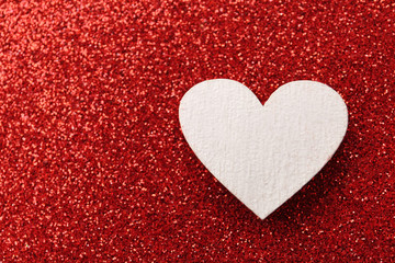 White wooden heart on red shiny background, top view. Space for text