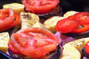 Meat with potatoes, eggplant, tomatoes and spices ready for cooking