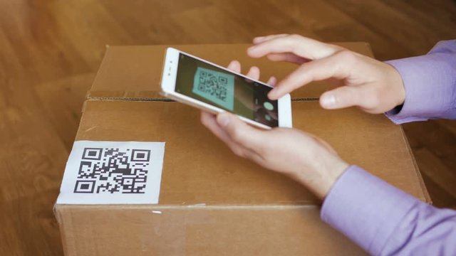 Scanning QR code with smart phone. The man reads the bar code using the application on the smartphone.