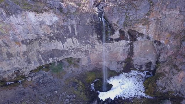 Thin 60M waterfall with snow and ice at the base