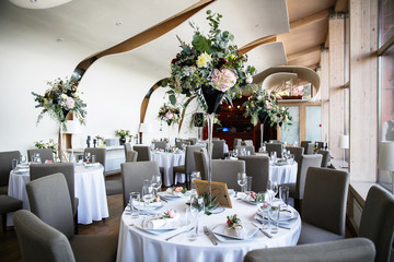 catering at a top event, glasses and flowers on the table, preparation for a significant event, beautiful dishes and glasses on the table, New Year's holiday table