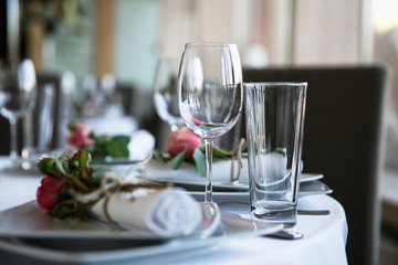 catering at a top event, glasses and flowers on the table, preparation for a significant event, beautiful dishes and glasses on the table, New Year's holiday table