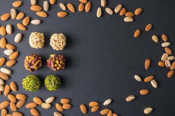Middle east pistachio confectionery. Healthy no sugar food. Oval scattered pistachio and almond nuts. Copy space. Top view.