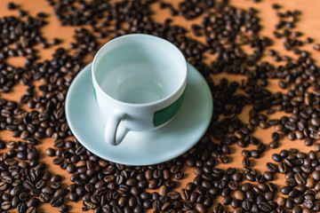 cup of coffee with beans on wooden background