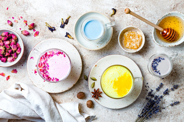Variety of Moon Milk for a better sleep. Turmeric golden milk, pink rose milk, blue butterfly pea and lavender moon milk. Trendy relaxing bedtime drink