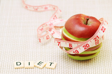 An apple and flexible ruler as a concept of dieting and weight control	