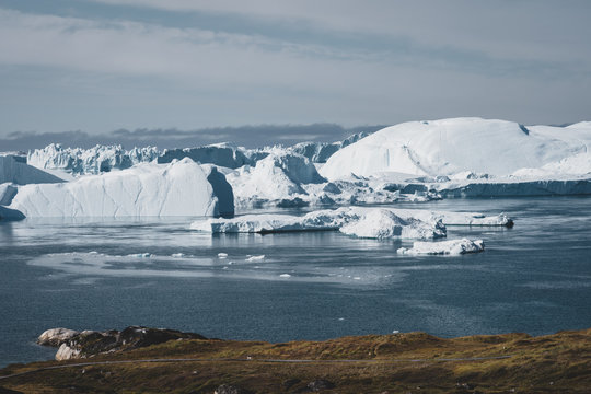 View towards Icefjord in Ilulissat. Easy hiking route to the famous Kangia glacier near Ilulissat in Greenland. The Ilulissat Icefjord seen from the viewpoint. Ilulissat Icefjord was declared a UNESCO
