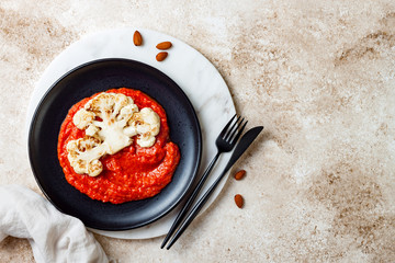 Roasted cauliflower steak with red pepper romesco sauce